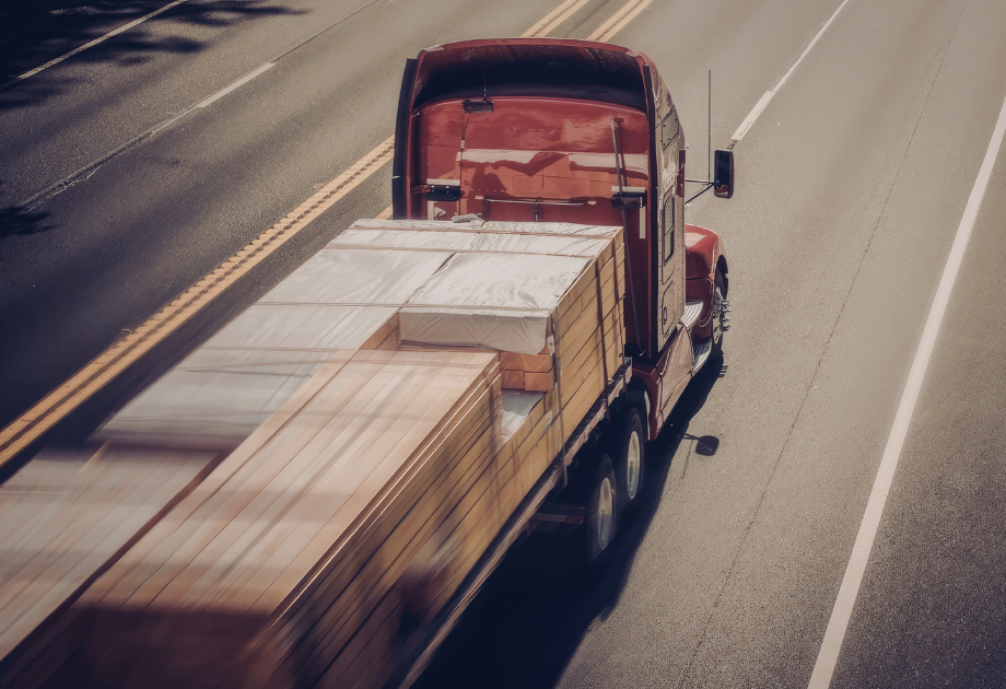 aerial view of a loaded semi driving on the highway